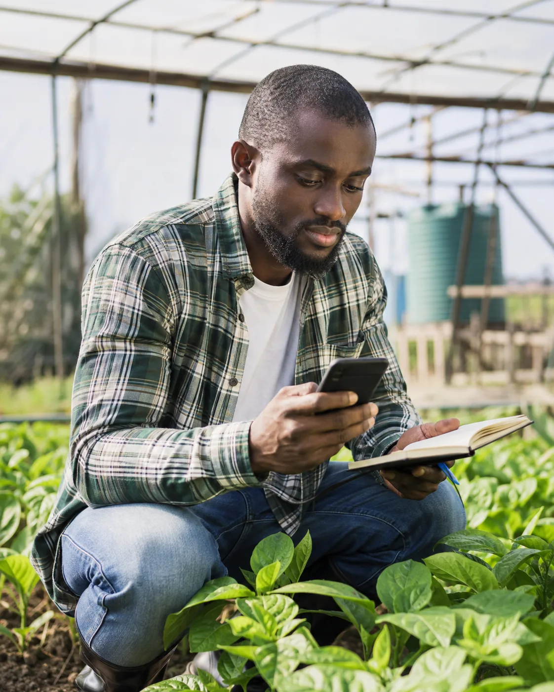 Agriculture learner taking notes among plants