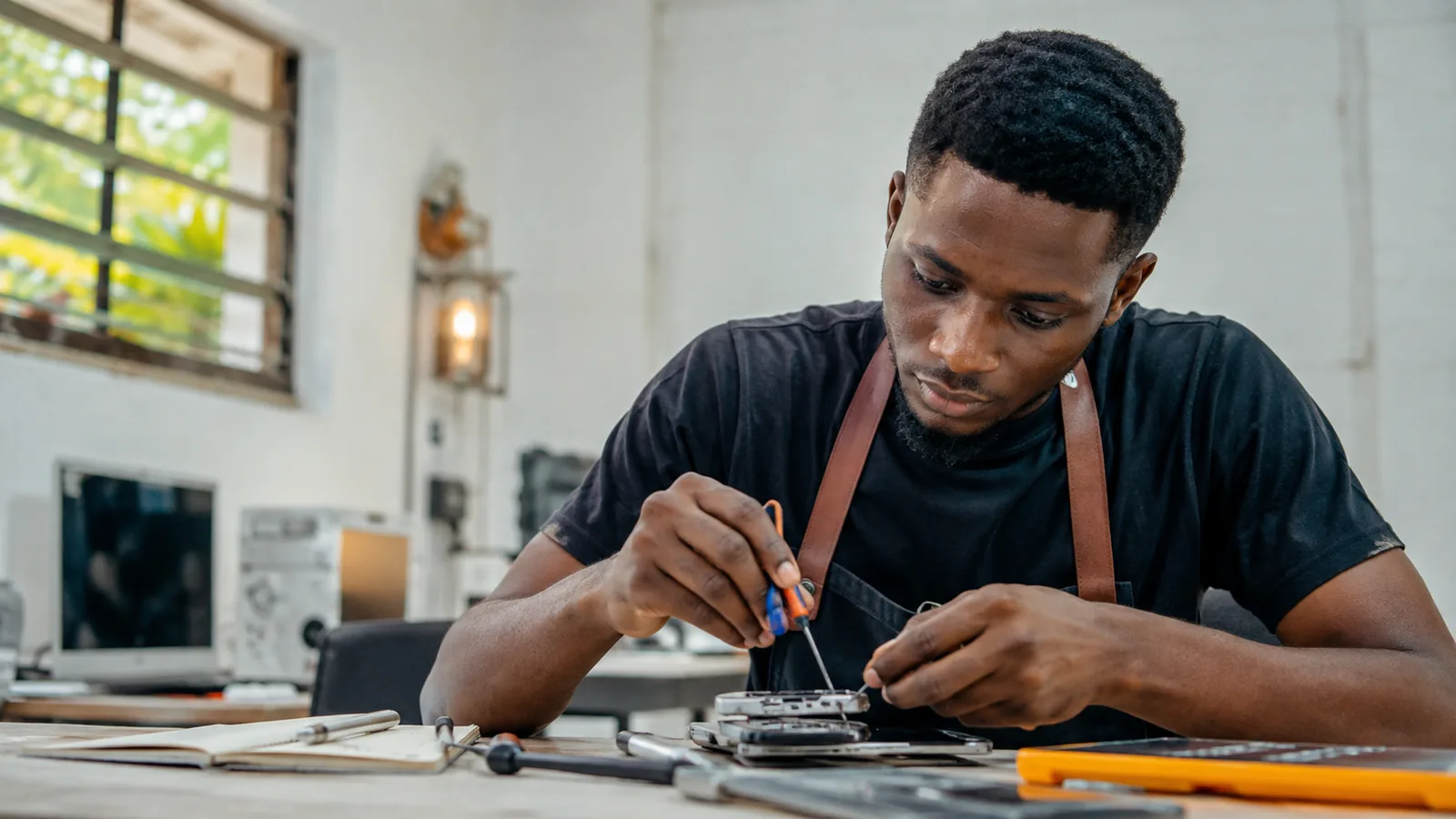 Learner practising a technical skill at a workbench